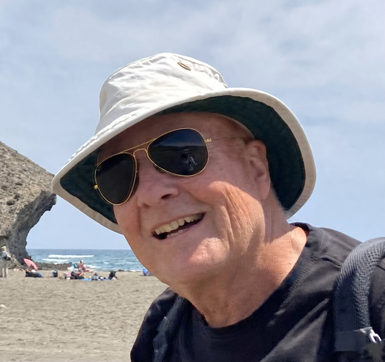 Headshot of Prof Alastair Fraser who is wearing a white hat and dark glasses, and a dark jumper.